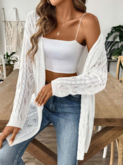 White openwork diamond knit duster cardigan with long sleeves and open front, styled with a white crop top and jeans.