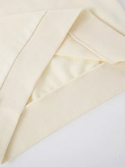 Cream crew-neck sweatshirt detail showing ribbed cuffs and hem.