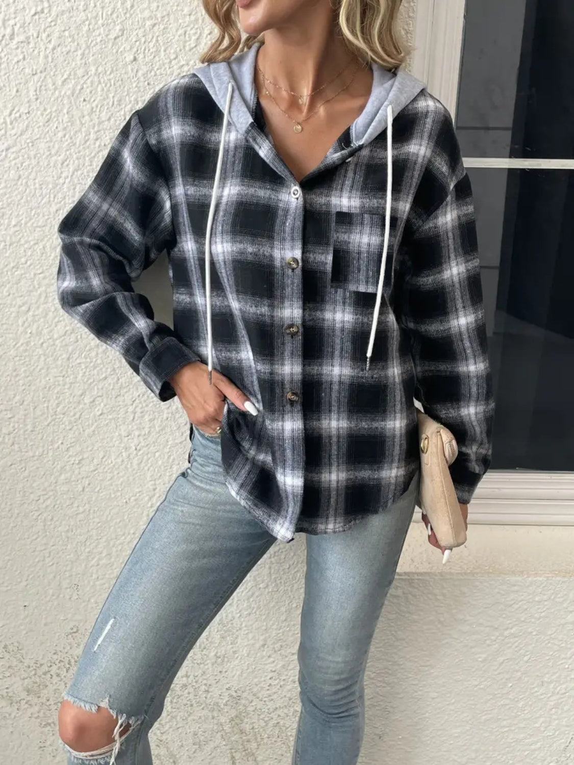Plaid shirt jacket with contrast hood in black and white, featuring button front and white drawstrings.
