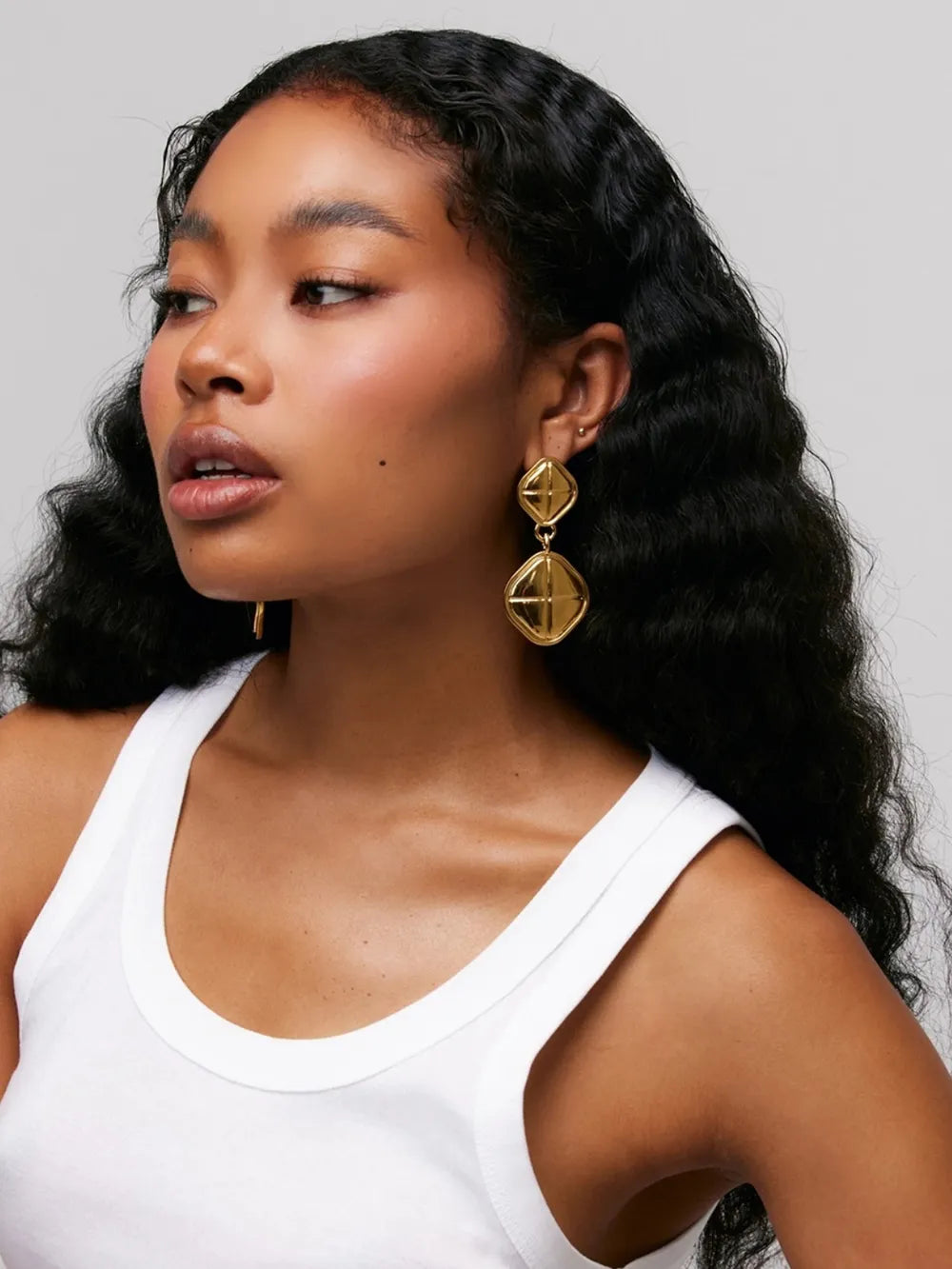 Gold 18K gold-plated sculpted geo drop earrings with diamond-shaped pendants.