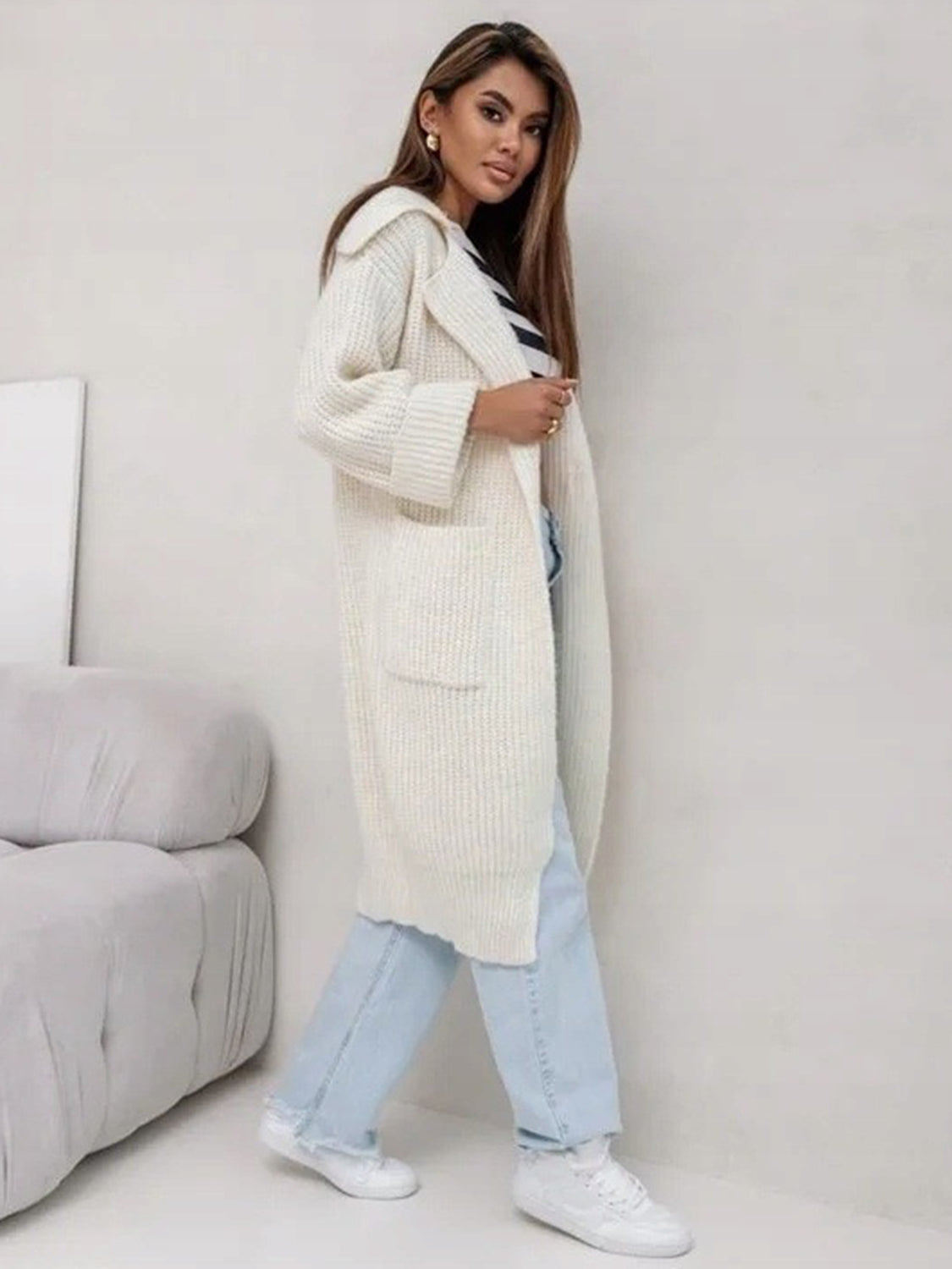 Cream oversized knit lapel cardigan with pockets and cuffed sleeves.