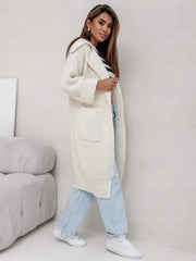 Cream oversized knit lapel cardigan with pockets and cuffed sleeves.
