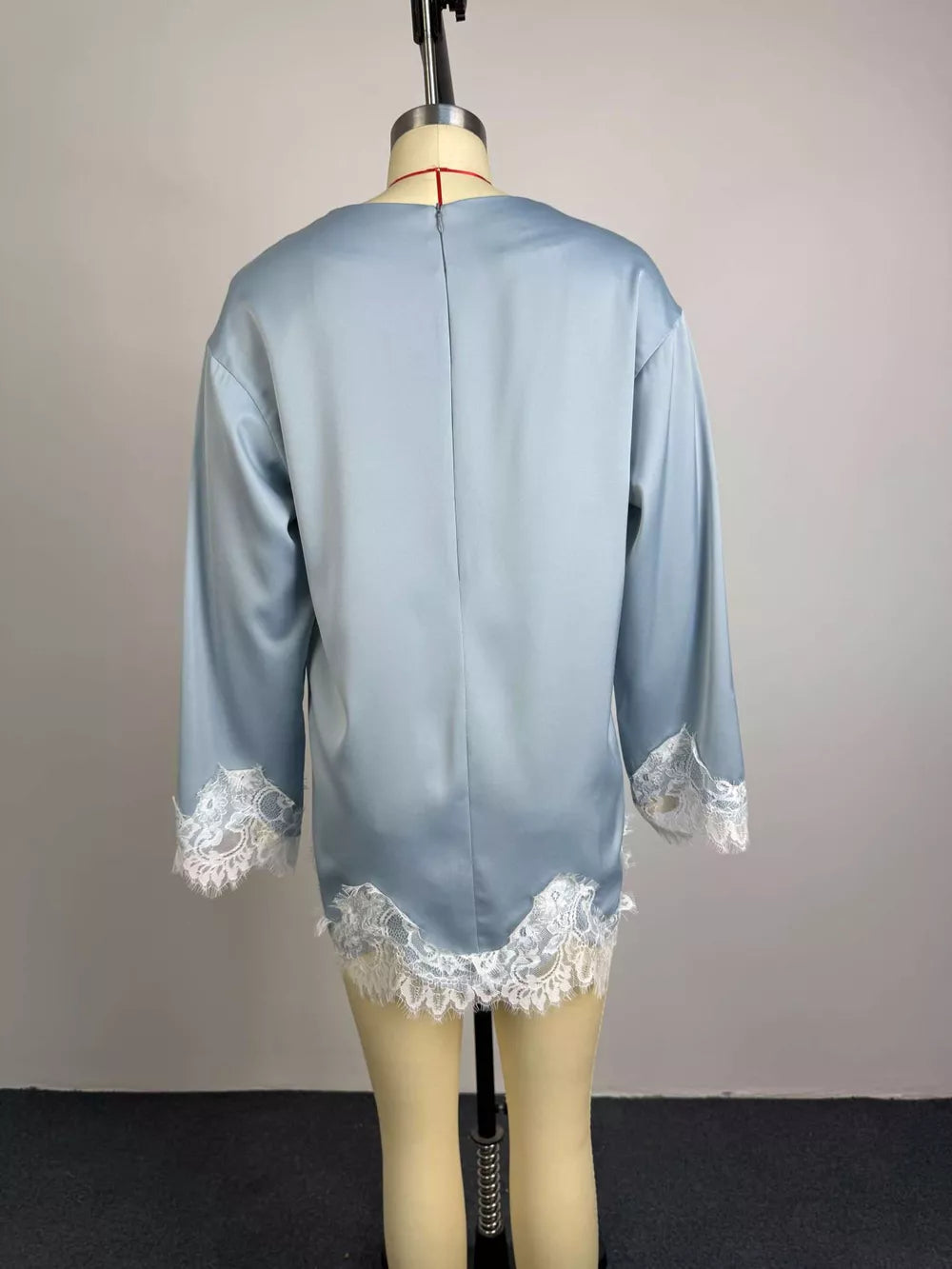 Light blue satin maternity t-shirt with oversized fit and white lace trim on sleeves and hem.