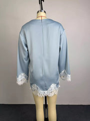 Light blue satin maternity t-shirt with oversized fit and white lace trim on sleeves and hem.