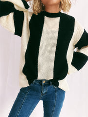 Black and cream vertical stripe waffle knit sweater with crewneck and long sleeves.