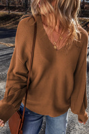 Brown ribbed knit pullover sweater with balloon sleeves and V-neck.