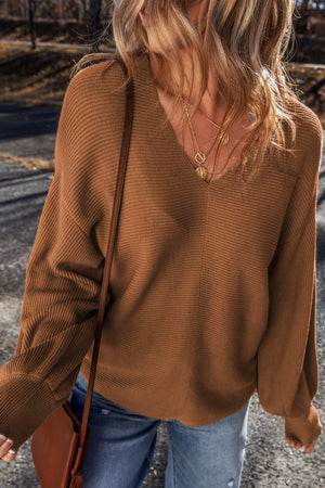 Brown ribbed knit pullover sweater with balloon sleeves and V-neck.