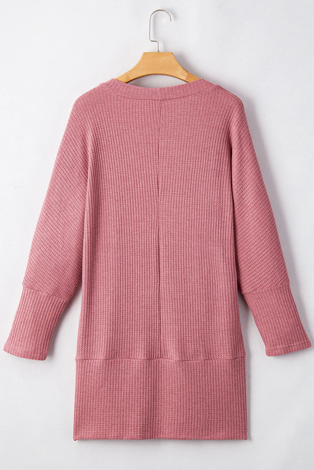Dusty pink waffle knit open front cardigan with long sleeves and a relaxed fit.