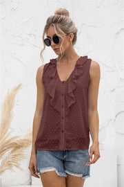 Brown sleeveless blouse with textured dot pattern and ruffle V-neck.