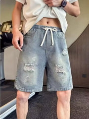 Distressed denim shorts with adjustable drawstring and elastic waist.