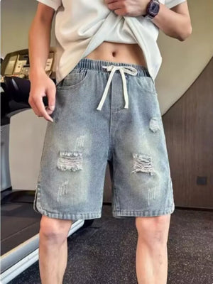 Distressed denim shorts with adjustable drawstring and elastic waist.