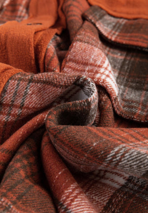 Colorblock plaid shacket in terracotta with contrast cuffs and button detail.