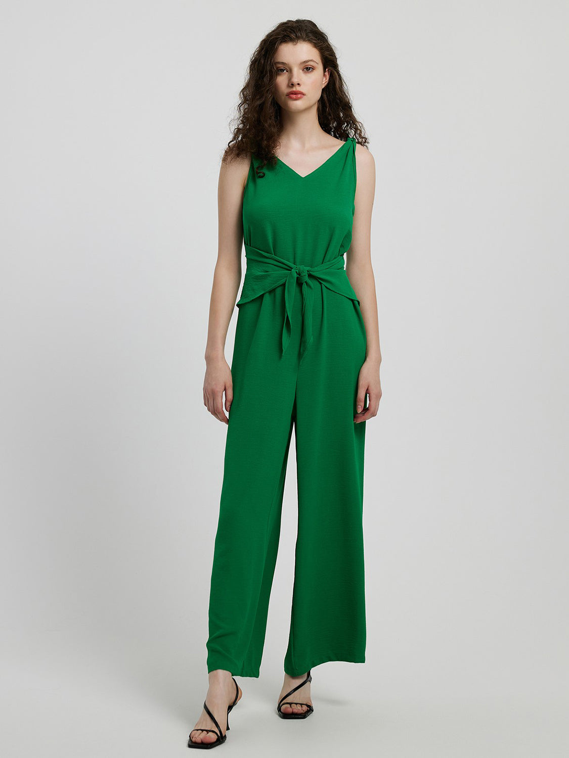 Emerald green tie-waist wide leg jumpsuit with V-neck and sleeveless design