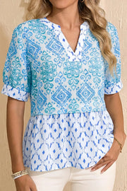 Patchwork babydoll maternity overshirt with puff sleeves, V-neck, and blue & white ikat print.
