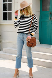 Sweater with black and white stripes and colorful cuffs, acrylic, crew neck, long sleeves.