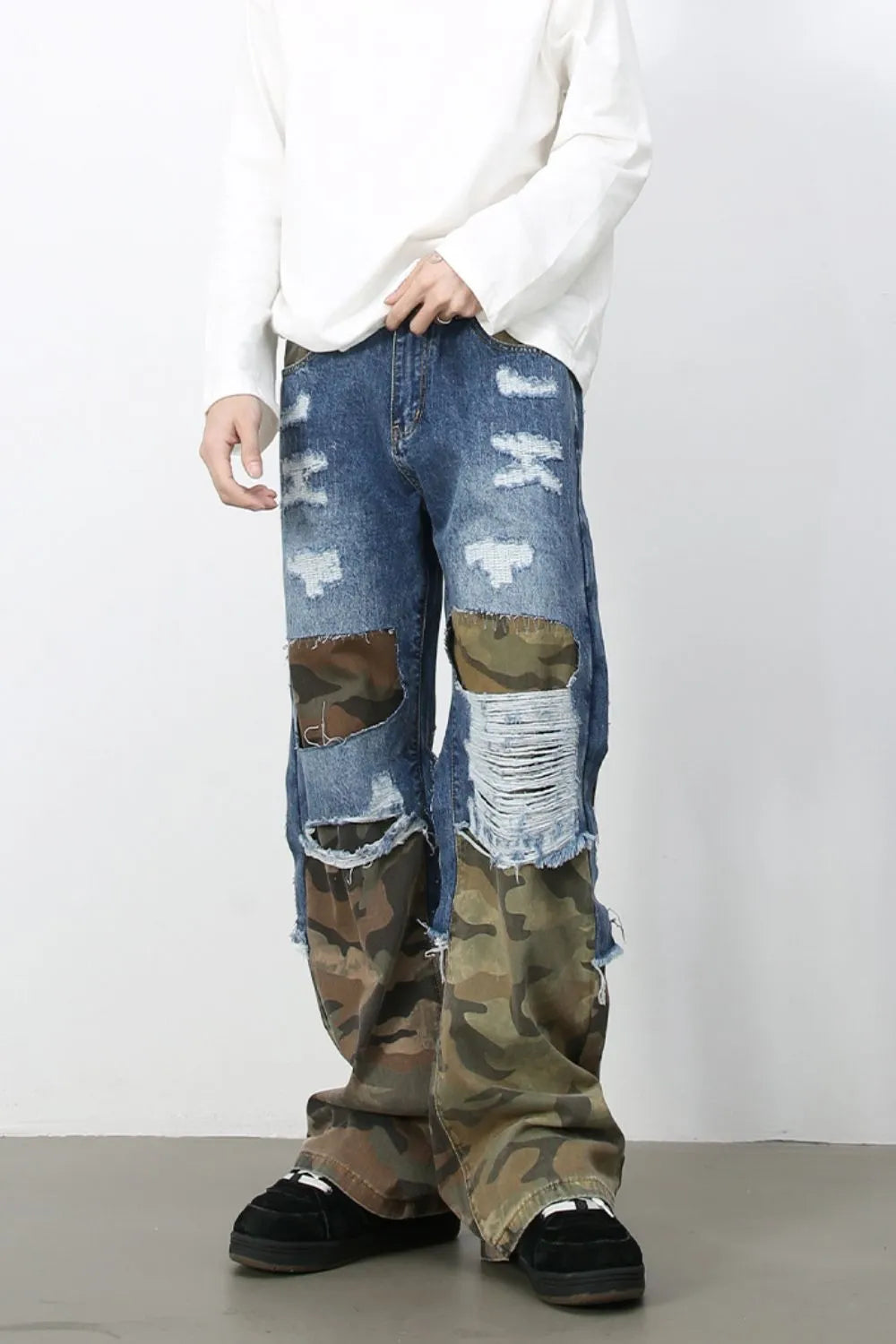 Camouflage patchwork distressed baggy jeans with ripped detailing and frayed hems.