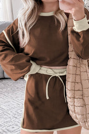 Coffee brown sweatshirt and skort set with contrast trim and drawstring waist.