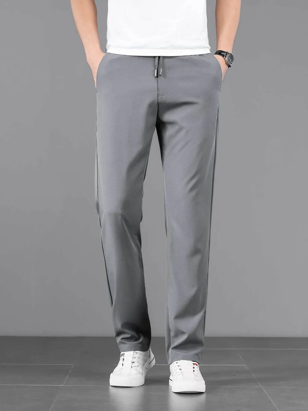 Grey casual drawstring sweatpants with side stripe detail and pockets.