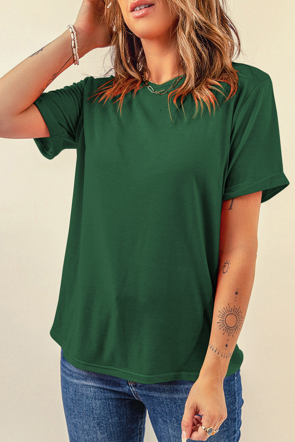 Dark green t-shirt with rolled short sleeves and a crew neck.