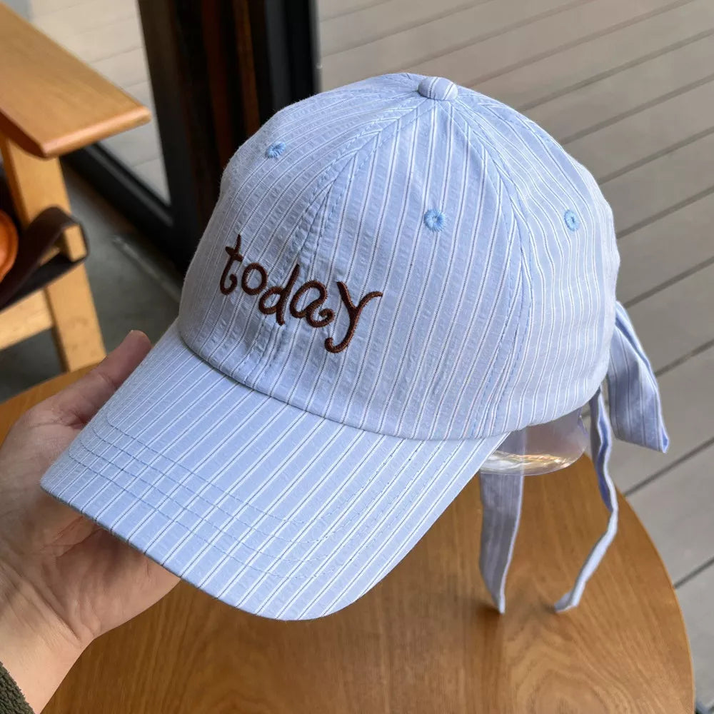 Light blue pinstripe cotton baseball cap with embroidered "today" text and tie back detail.