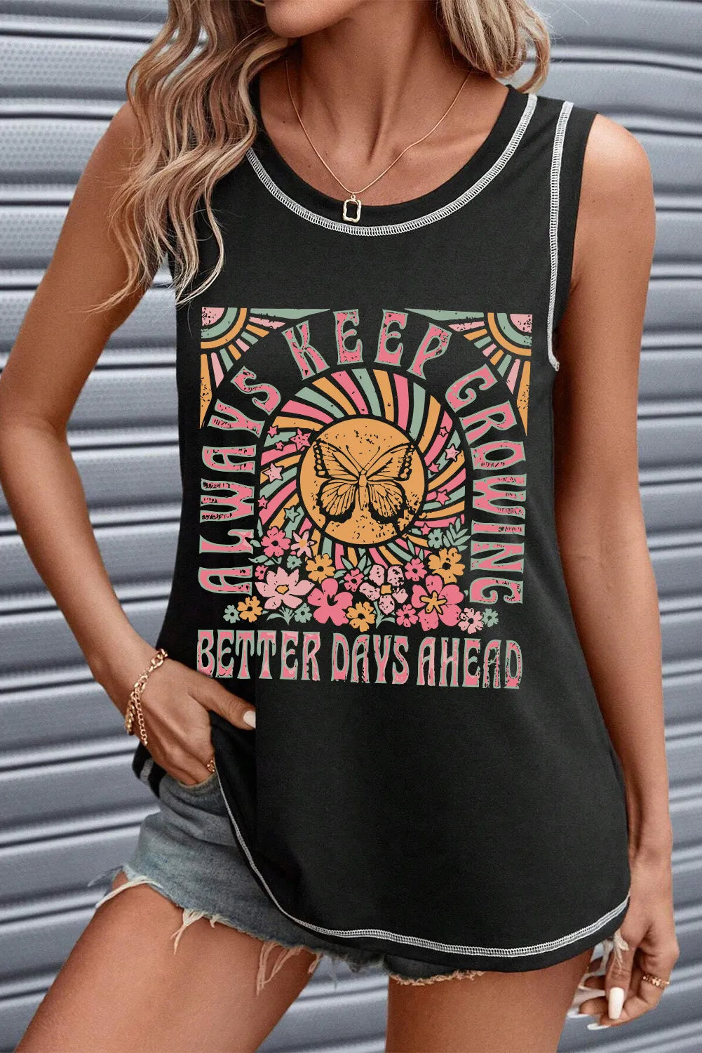 Black graphic tank top with contrast stitching and a butterfly and floral print saying "Always Keep Growing Better Days