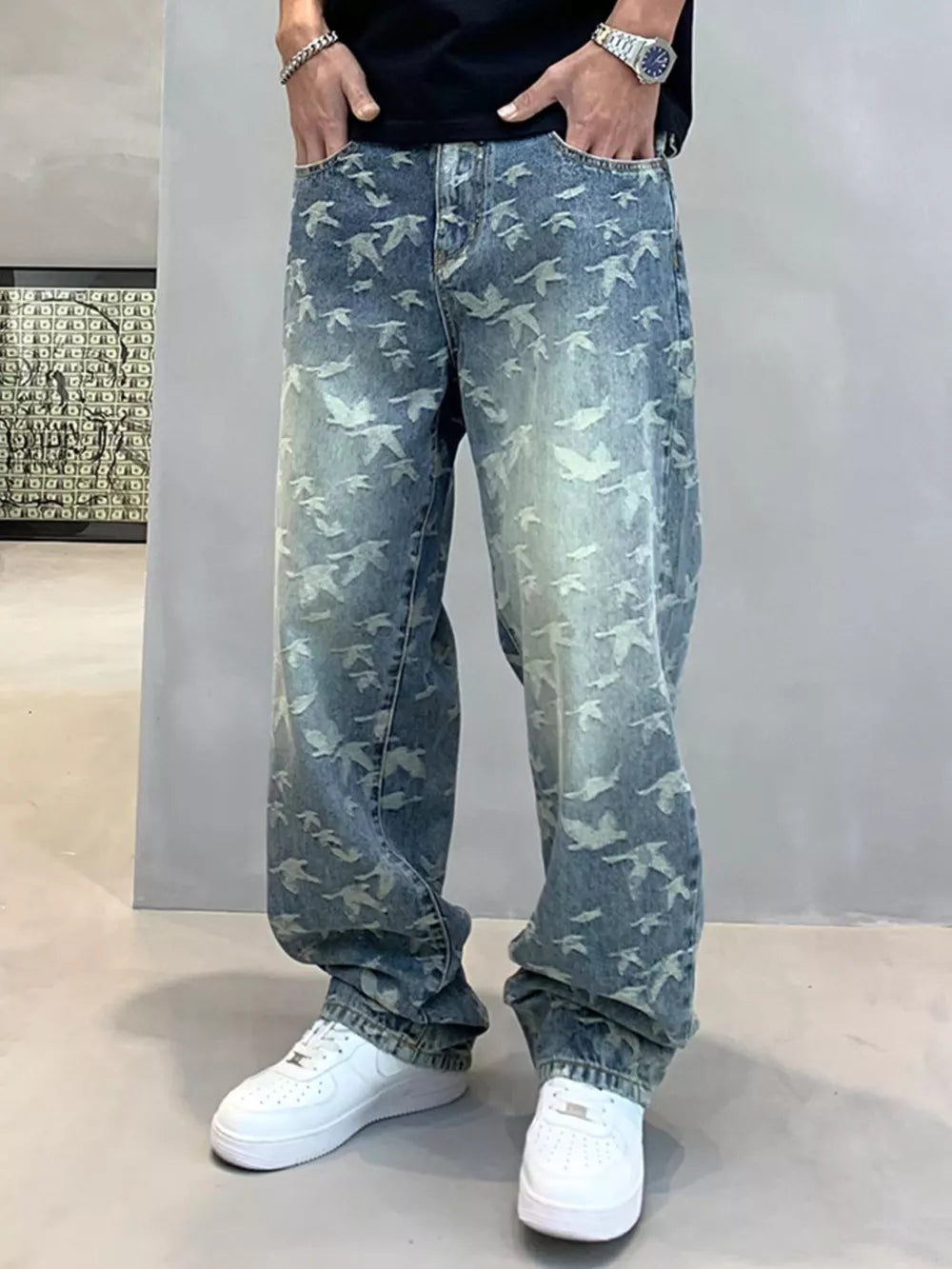 Loose-fit denim jeans with all-over bird print and vintage wash.