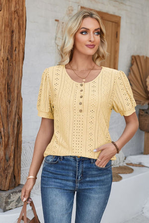 Light yellow perforated puff sleeve henley blouse with button placket and eyelet details.