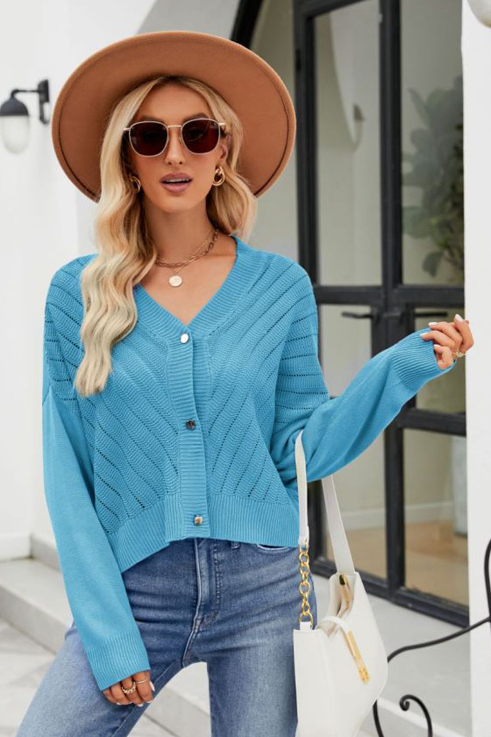 Sky blue textured stitch cropped v-neck cardigan with button front and long sleeves.