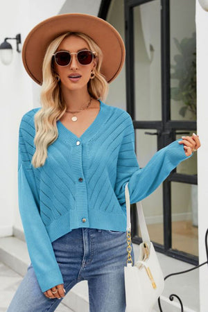 Sky blue textured stitch cropped v-neck cardigan with button front and long sleeves.