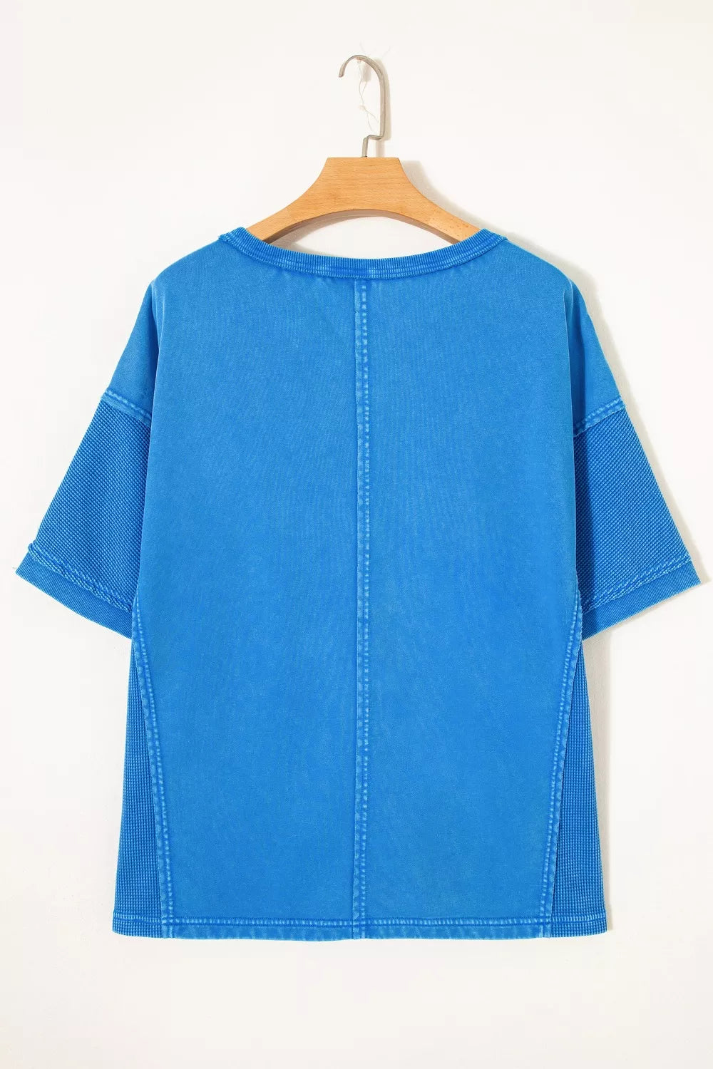 Blue mineral wash cotton tee with contrast mesh sleeves and seam details.