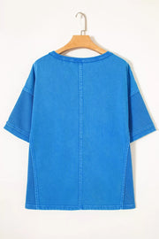 Blue mineral wash cotton tee with contrast mesh sleeves and seam details.