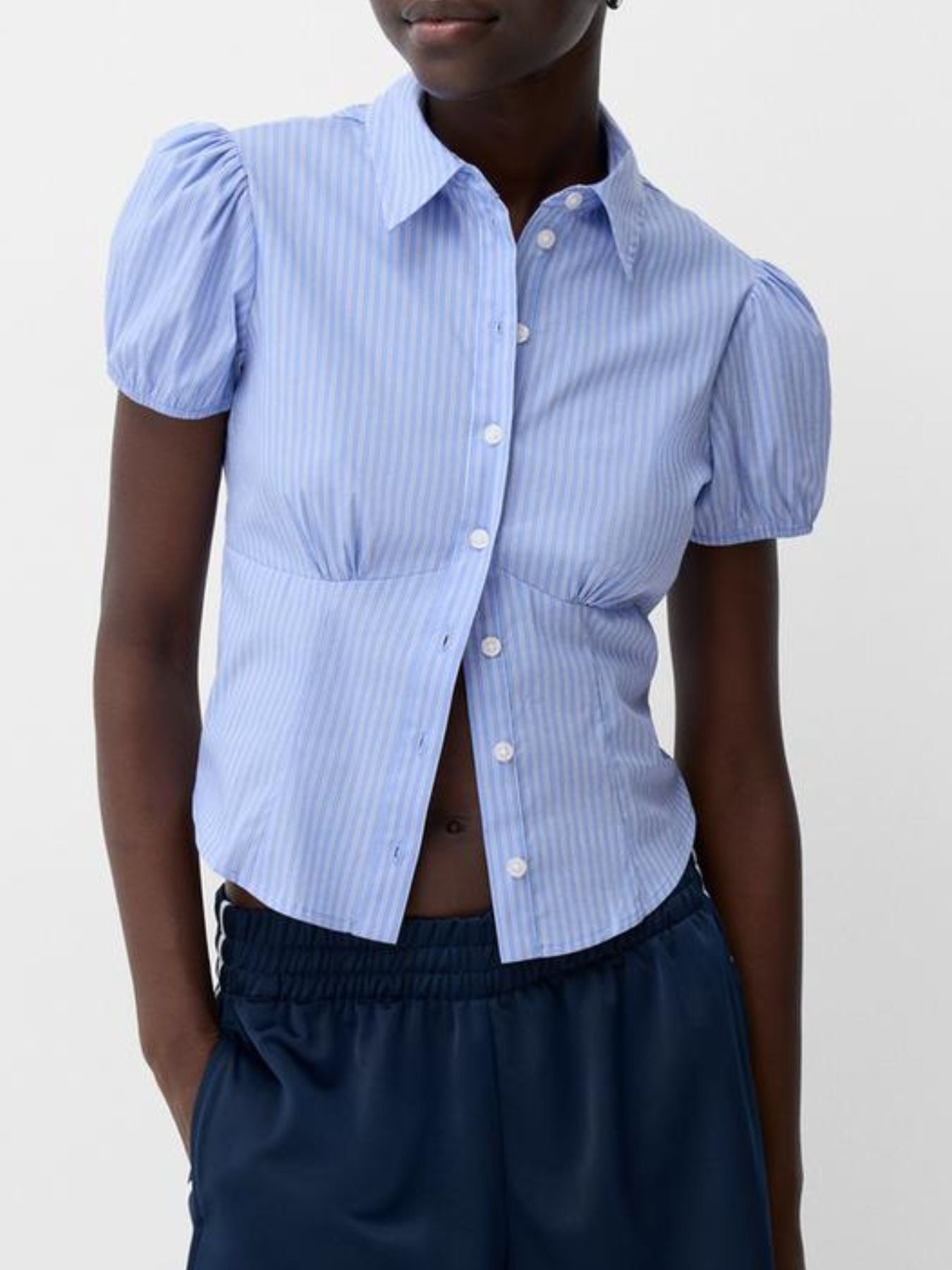 Light blue striped puff sleeve fitted button-up shirt with a collared neckline.