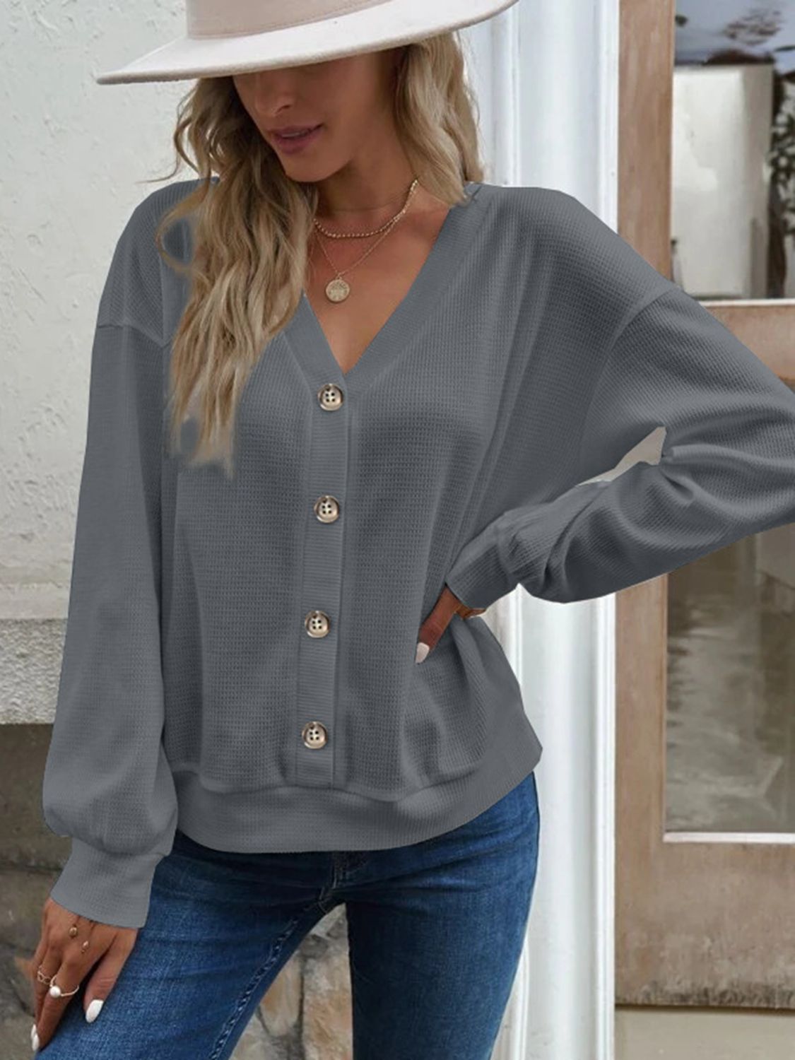 Dark gray waffle knit button-down cardigan with V-neck and gold buttons.