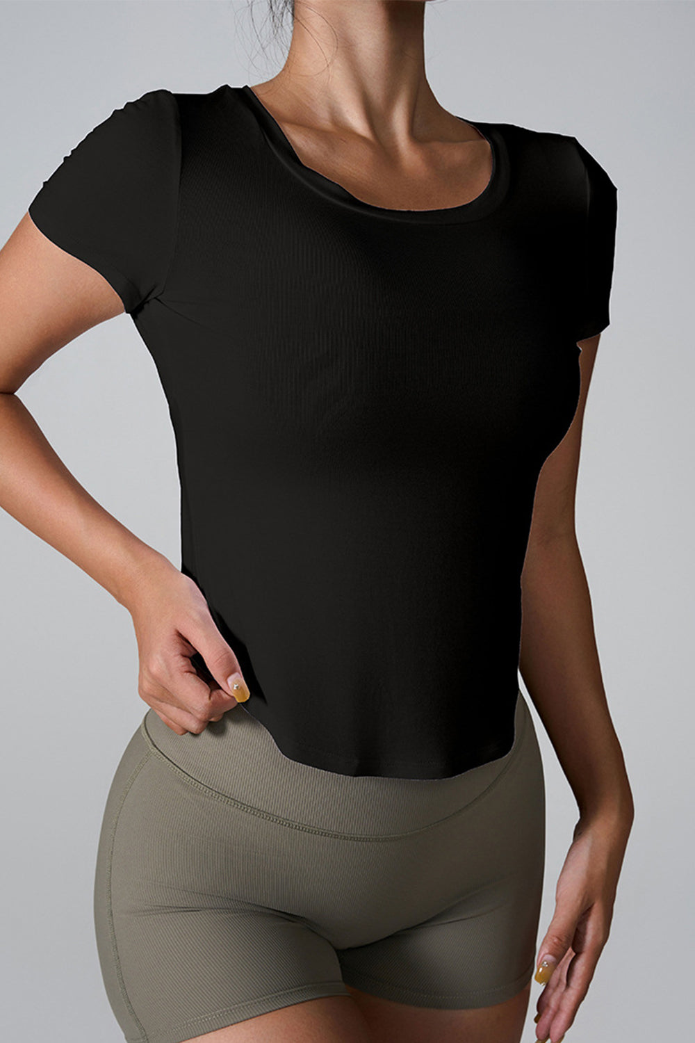 Black ribbed active tee with short sleeves and a scoop neck.