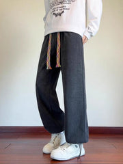 Men's gray textured wide leg sweatpants with a rainbow drawstring.