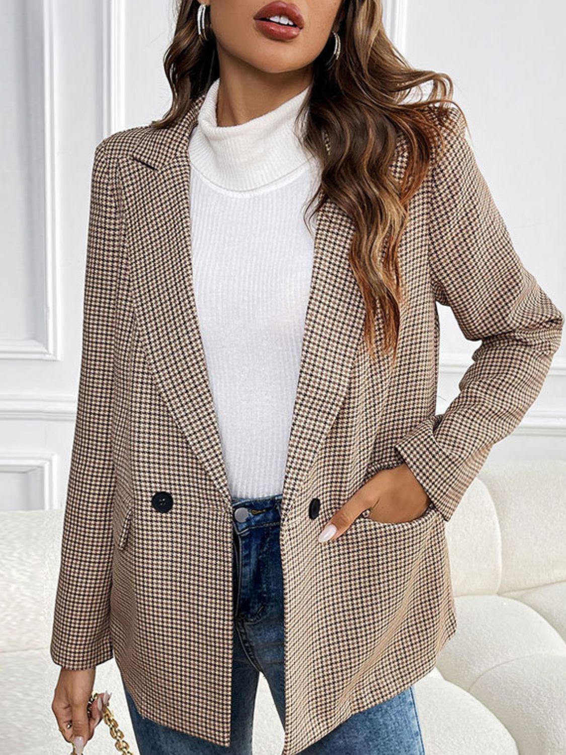 Houndstooth double-breasted blazer in camel with black buttons and flap pockets.