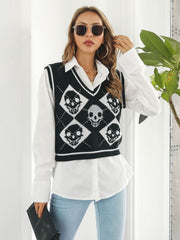 Black argyle knit vest with skull motif, V-neck, sleeveless, cropped length, 100% acrylic.