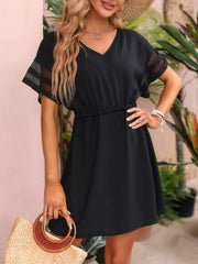 Black V-neck mini dress with sheer striped sleeves and elastic waist