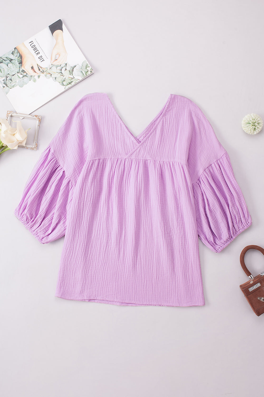 Textured gauze blouse in Heliotrope Purple with V-neck and gathered puff sleeves.