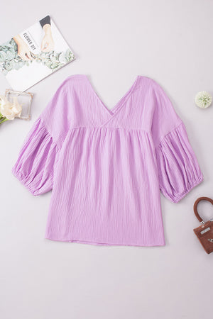 Textured gauze blouse in Heliotrope Purple with V-neck and gathered puff sleeves.