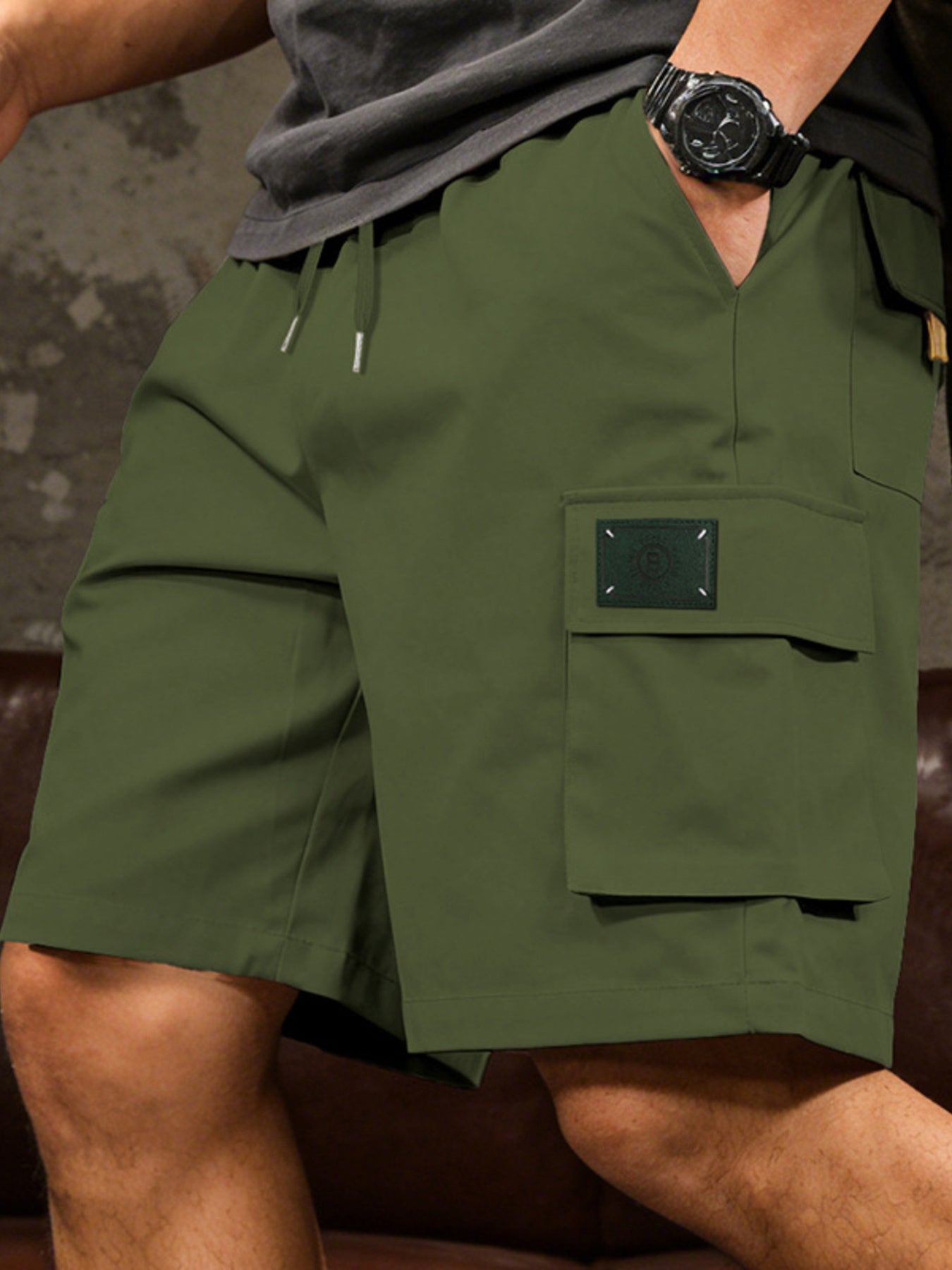 Army green cargo shorts with drawstring waist and multiple pockets.