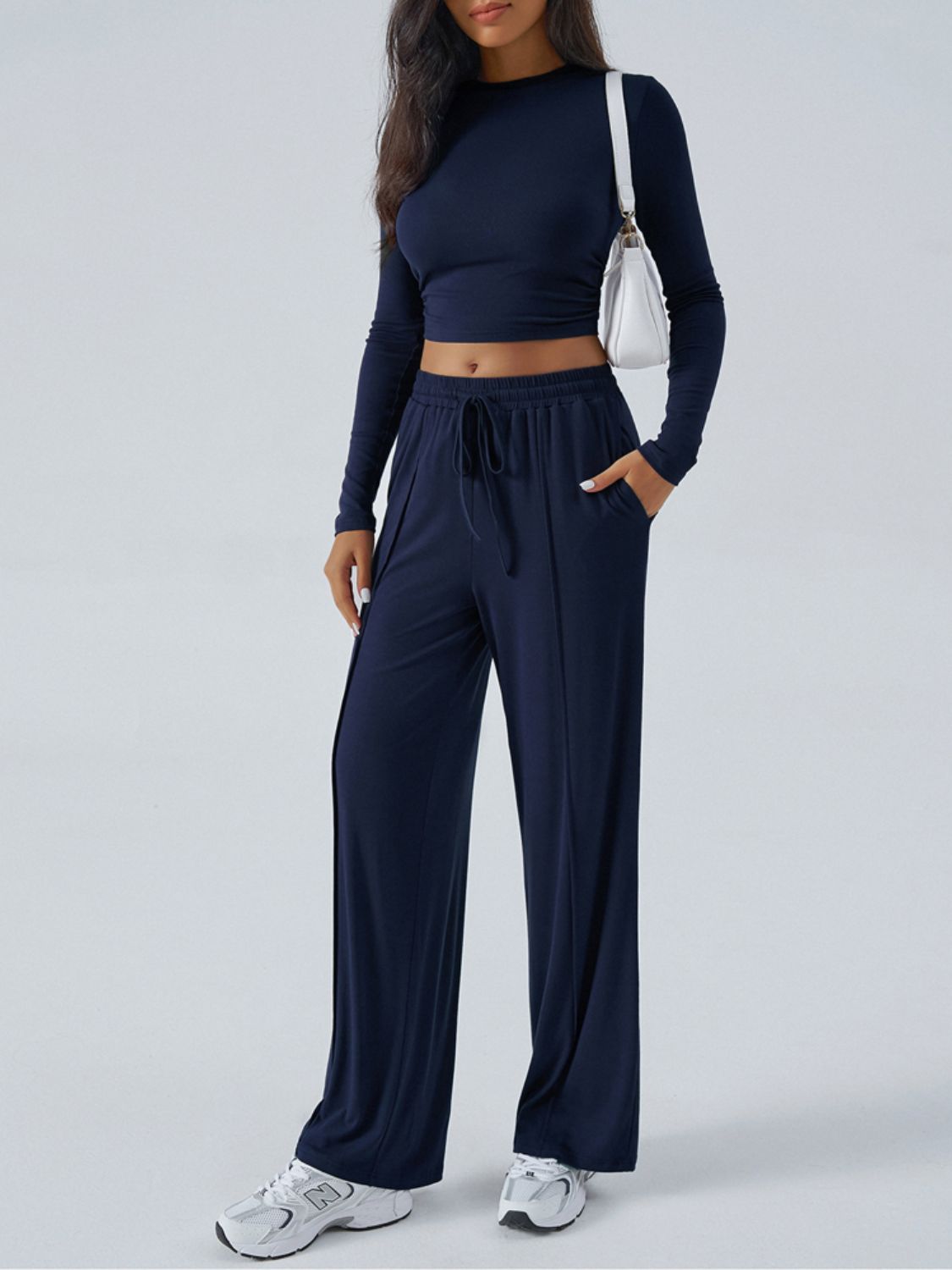 Dark blue ribbed knit crop top and wide leg pants set with drawstring waist and pockets.