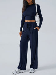 Dark blue ribbed knit crop top and wide leg pants set with drawstring waist and pockets.