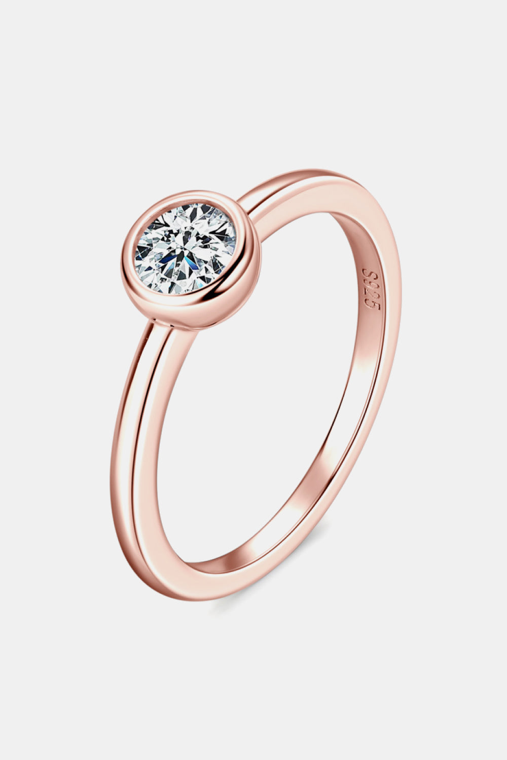 Rose gold solitaire bezel ring with a clear round-cut stone.