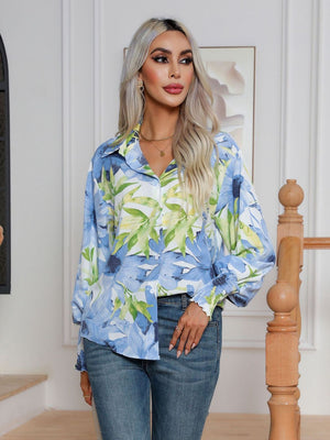 Light blue floral print blouson sleeve button-up shirt with smocked cuffs.