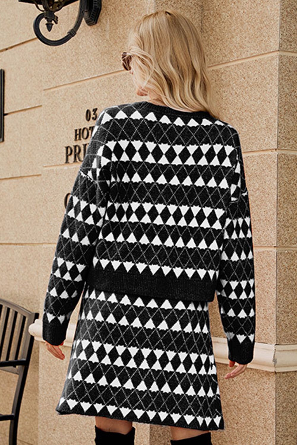 Black argyle knit cardigan and mini skirt set with buttoned front detail.