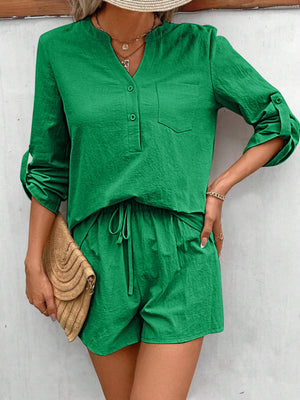 Green linen henley shirt with rolled sleeves and drawstring shorts set.
