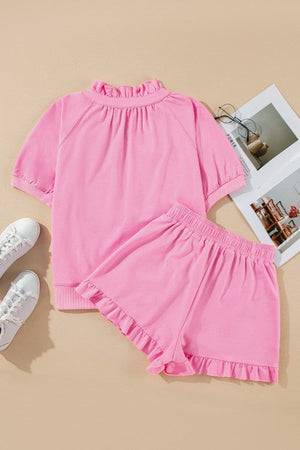 Pink cotton co-ord set with ruffled neckline and shorts.