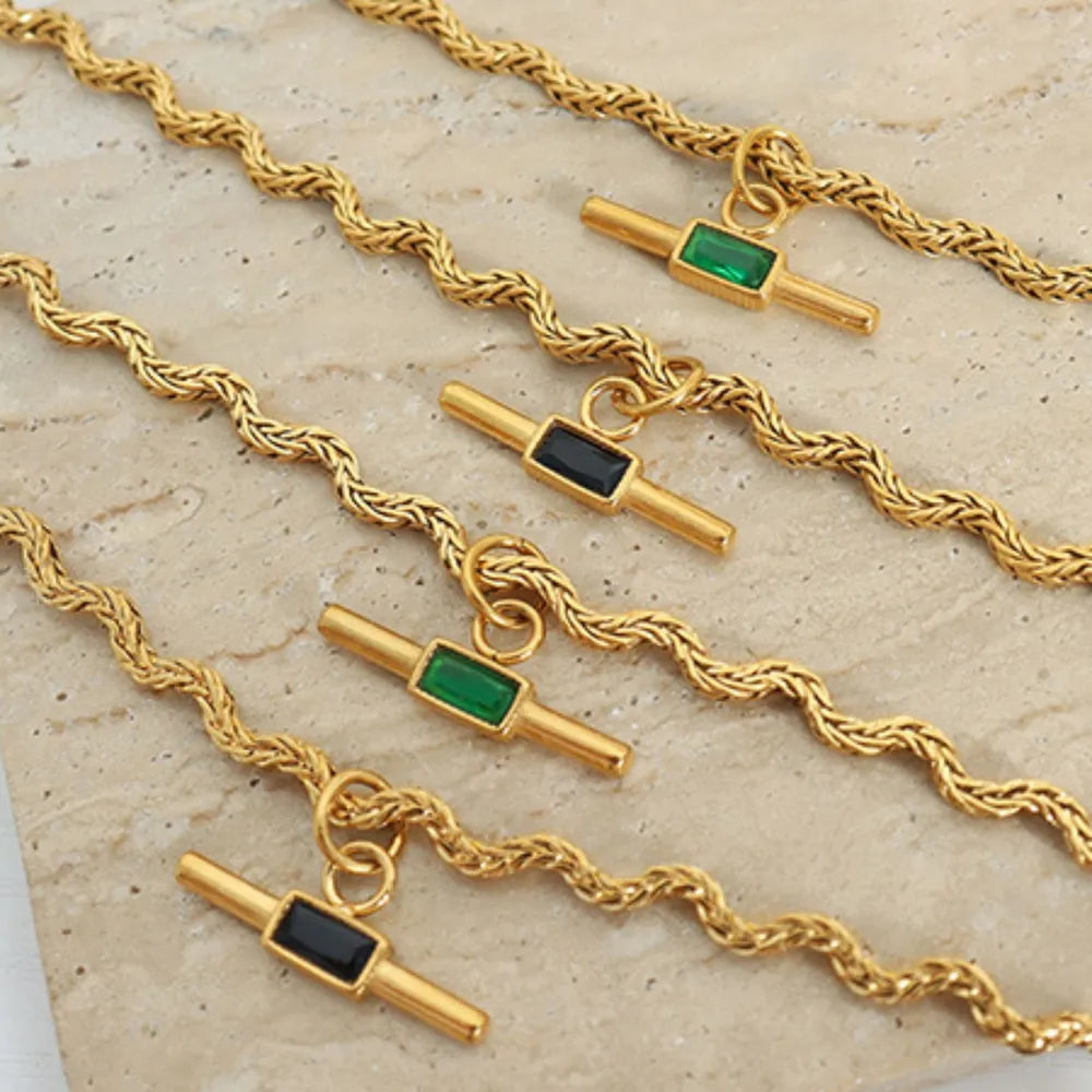 Gold rope chain necklace with emerald and black bar pendants