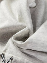 Light gray drawstring waist tunic sweatshirt detail with black and white striped drawstrings.